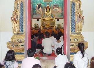 Devout Buddhists make merit at their local temple on Makha Bucha Day last year.
